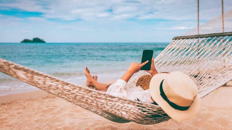 woman on phone in hammock