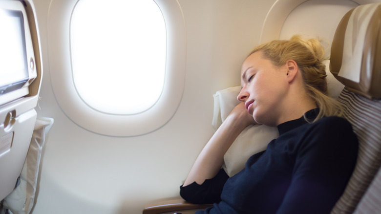 Woman sleeping on a plane 