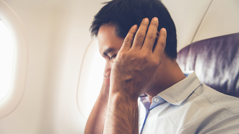 Passenger experiencing airplane ear