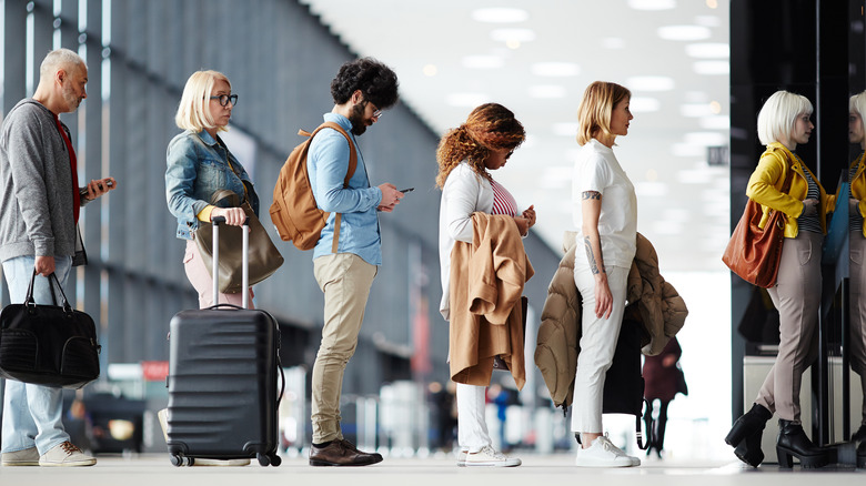 people standing in line at airport