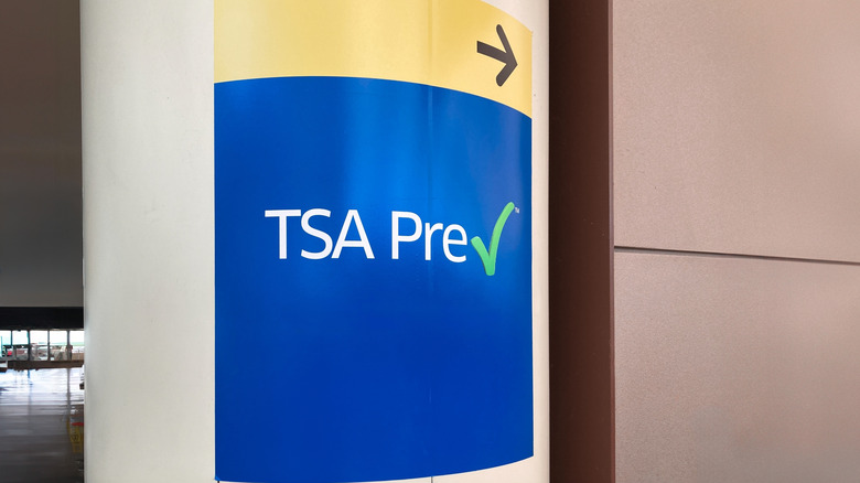 A sign pointing towards TSA PreCheck