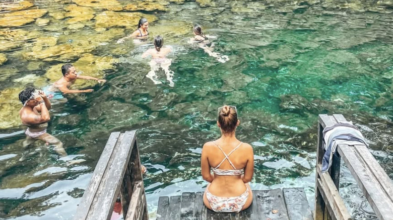 A traveler looking out at cenote tankah