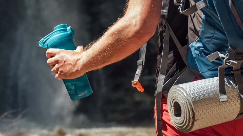 Camper with water bottle