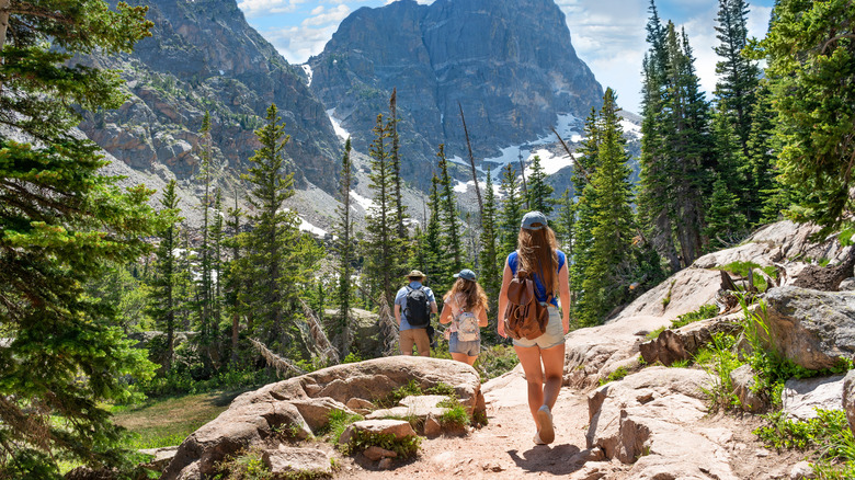 travelers hiking Rocky Mountains