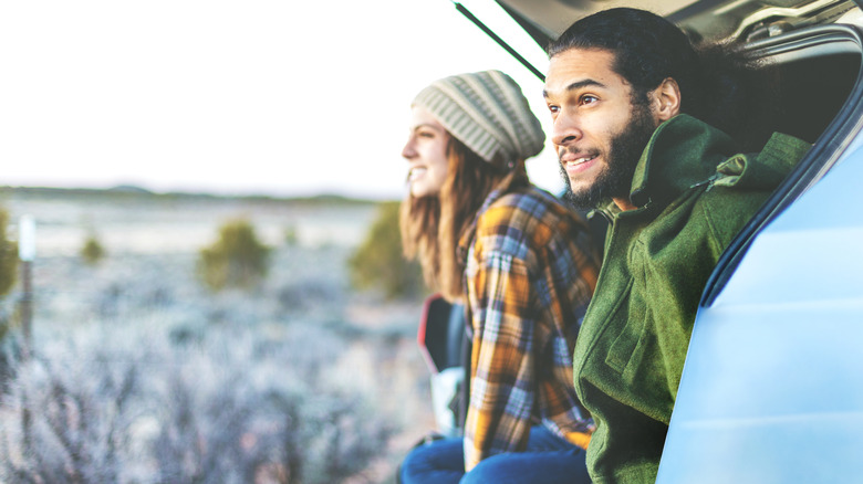 traveling couple in open car