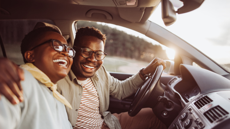 young couple driving car