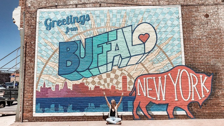 girl sitting infront of mural