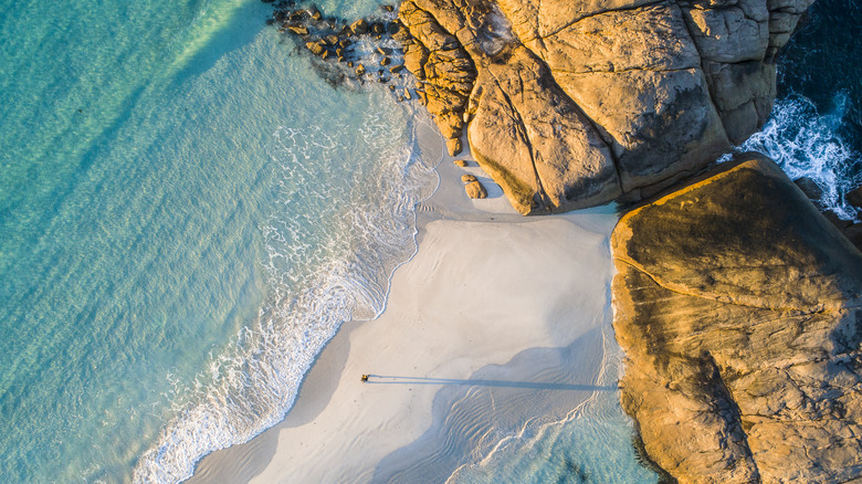 aerial view of beach and rock slabs