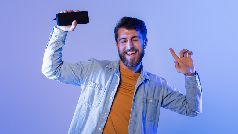 man holding bluetooth speaker