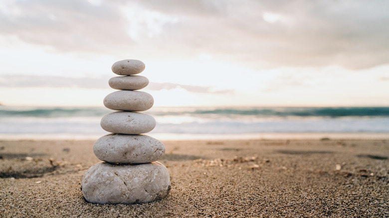 a stone cairn on sandy shore