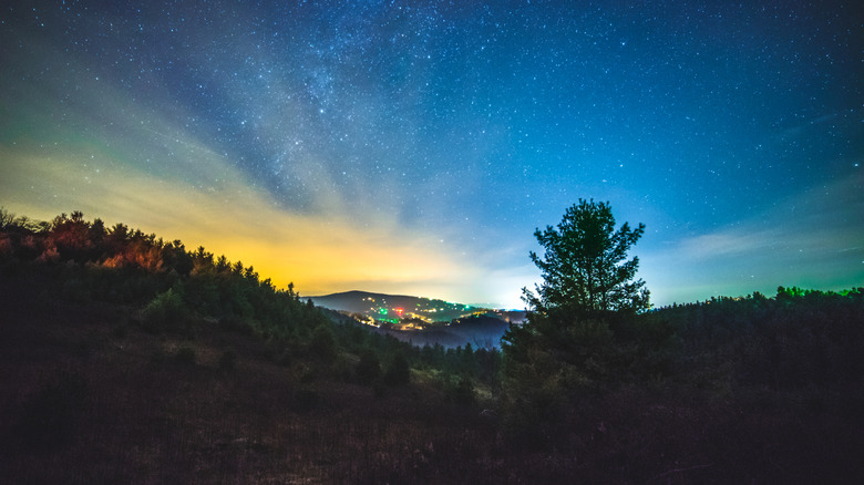 stars and town in distance from Blue Ridge Mountains
