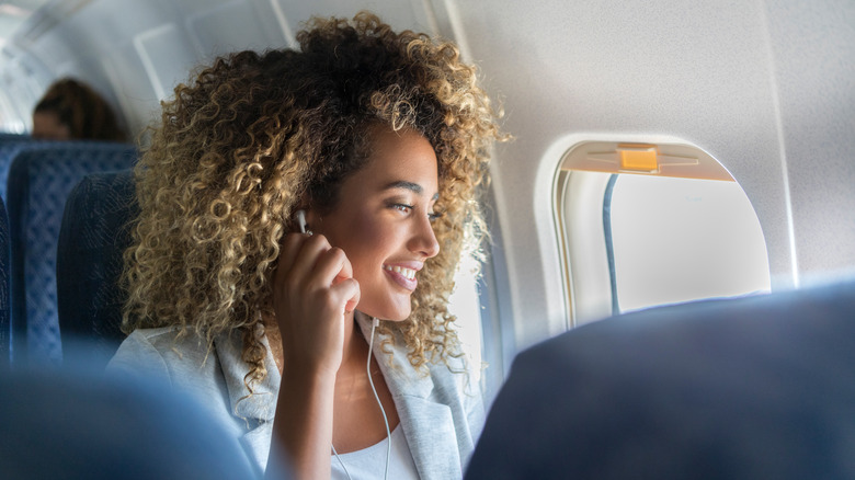 curly-haired woman on plane