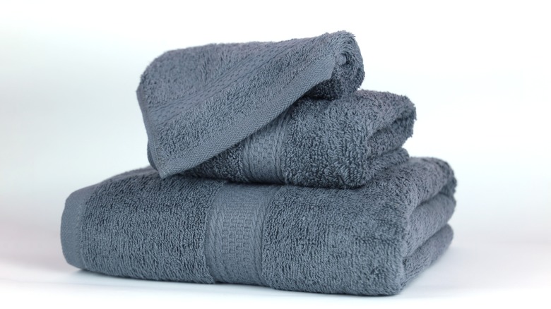 three stacked folded towel set on white background