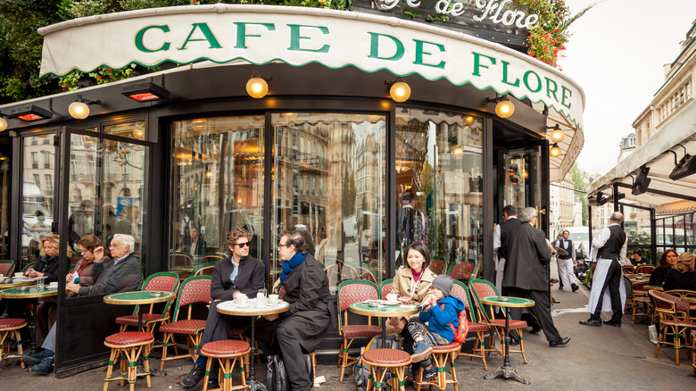 people sitting at outdoor cafe tables