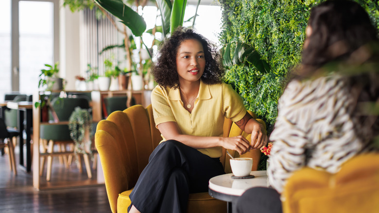 two people having coffee and talking