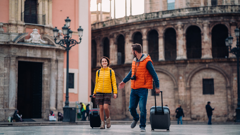 American tourists with luggage walking in Valencia, Spain