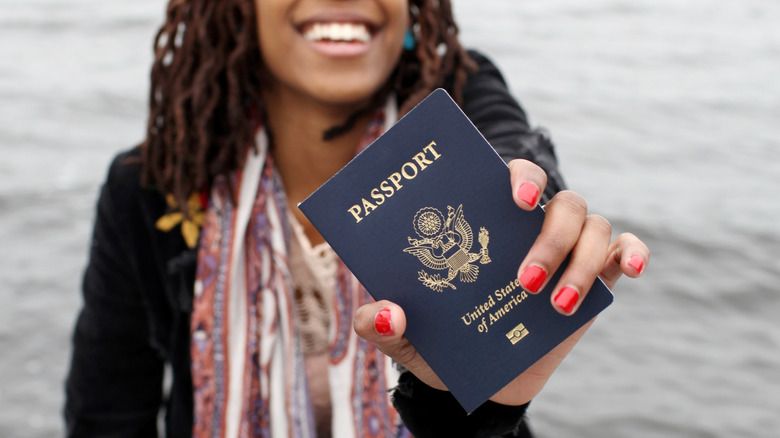 Woman smiling and holding a United States passport