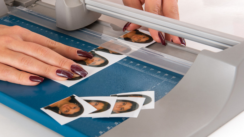 Woman cuts passport photos