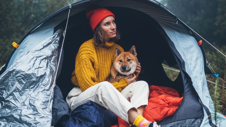 girl in tent with dog