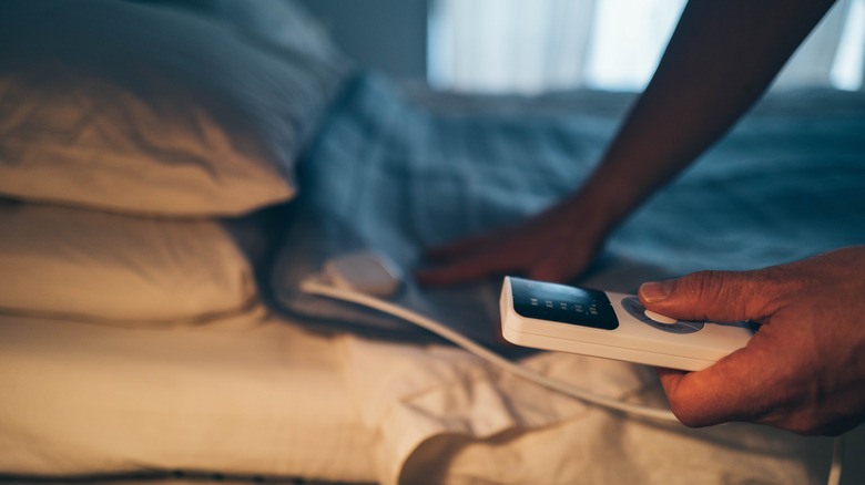 A heated blanket placed in a bed