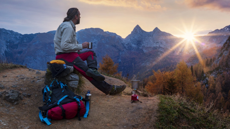 Hiker enjoying a meal at sunset