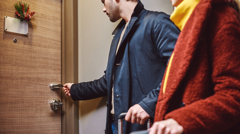 Couple arriving to hotel room