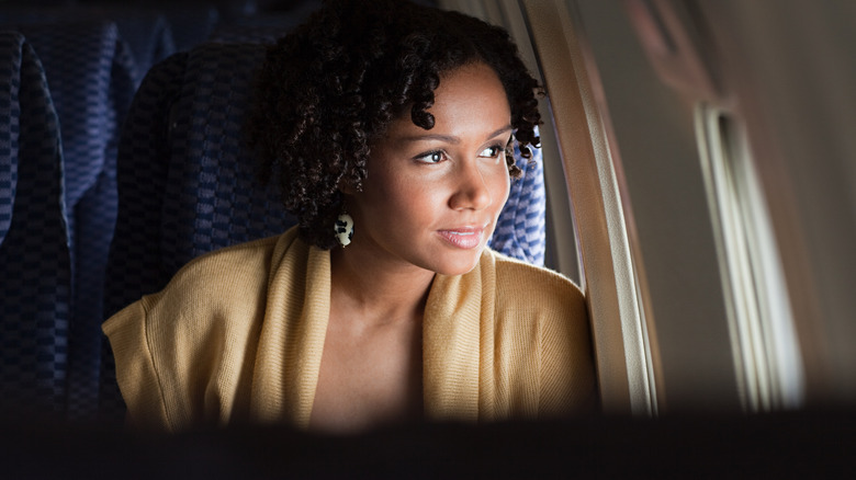 Traveler looking out plane window