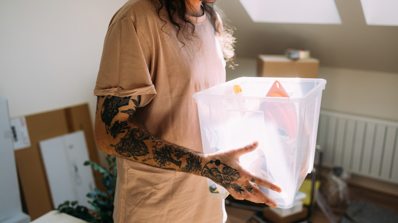 Person holding plastic storage box