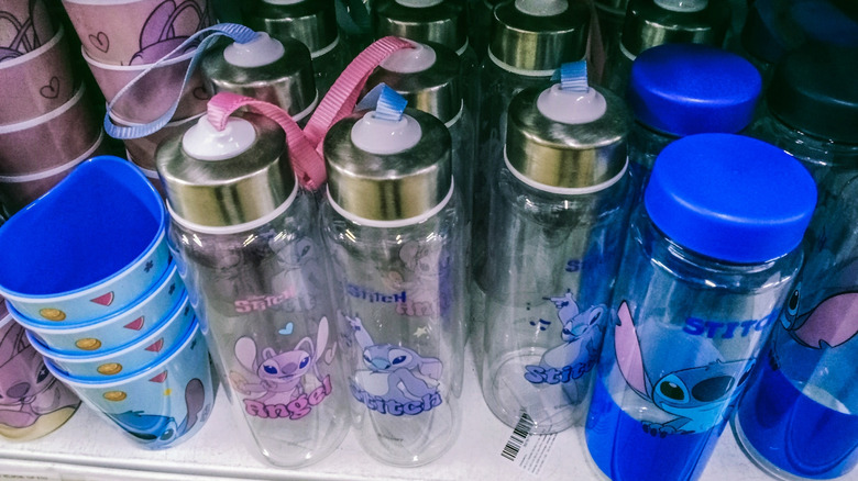 A shelf of water bottles depicting Disney Lilo and Stitch characters.