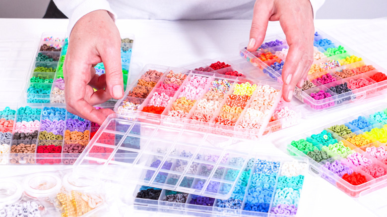 A table with several plastic bead organizers