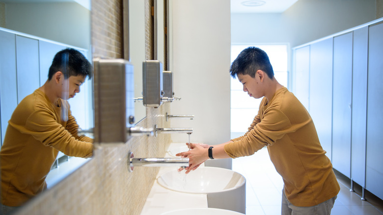 Boy washing his hands