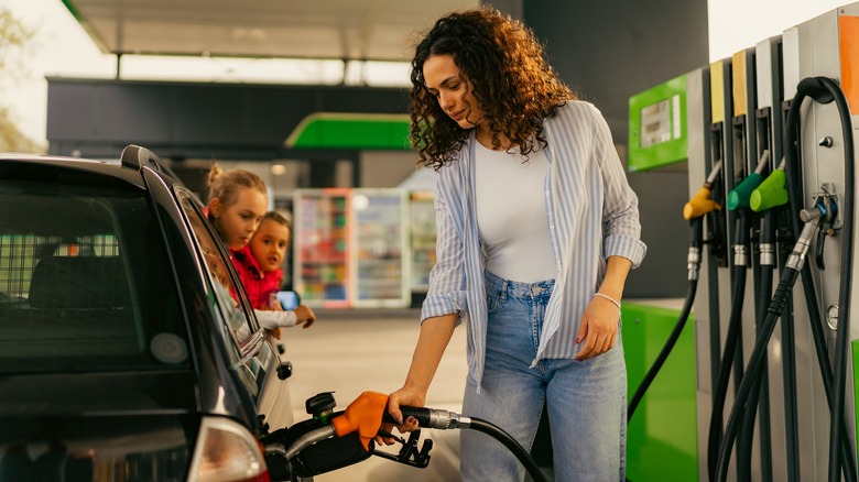 woman filling car with gas