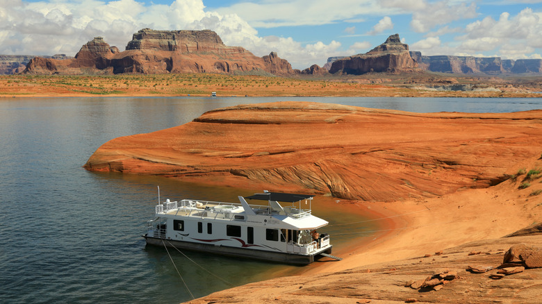 A houseboat is tied up on the shores of Lake Powell, Utah