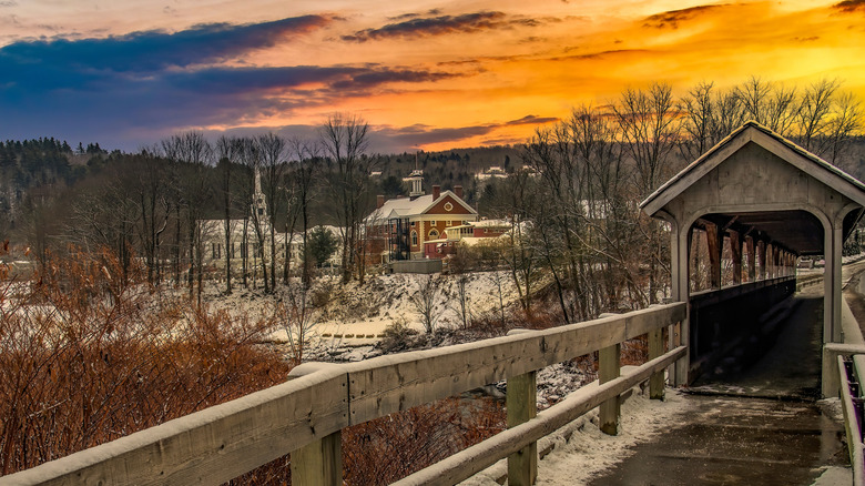 a pedestrian-only covered bridge leading into the historic center of Stowe, Vermont during the winter