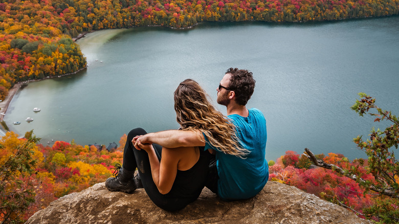 A couple enjoys fall views from above Lake Willoughby