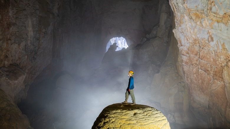 Man standing on a rock in Son Doong cave