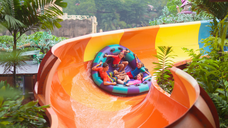 Children in a tube going down a water slide