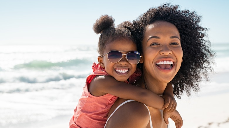 Mother and daughter smiling