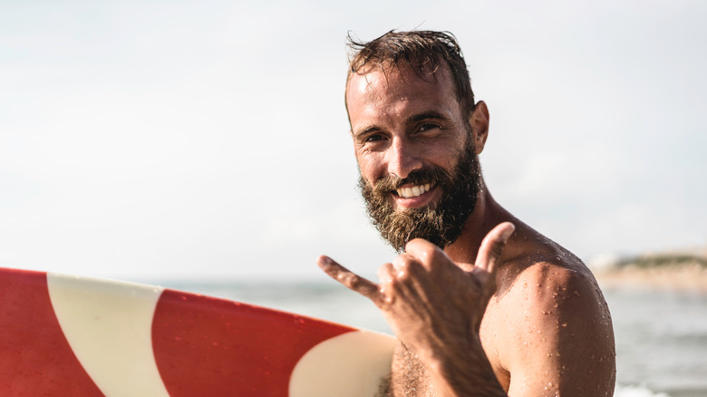 a surfer giving the Hawaiian hang-ten hand gesture