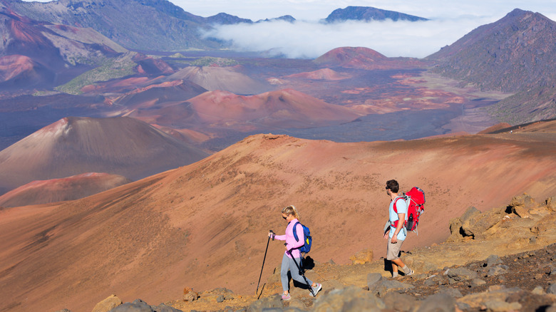 couple hiking volcano summit in Haleakala National Park