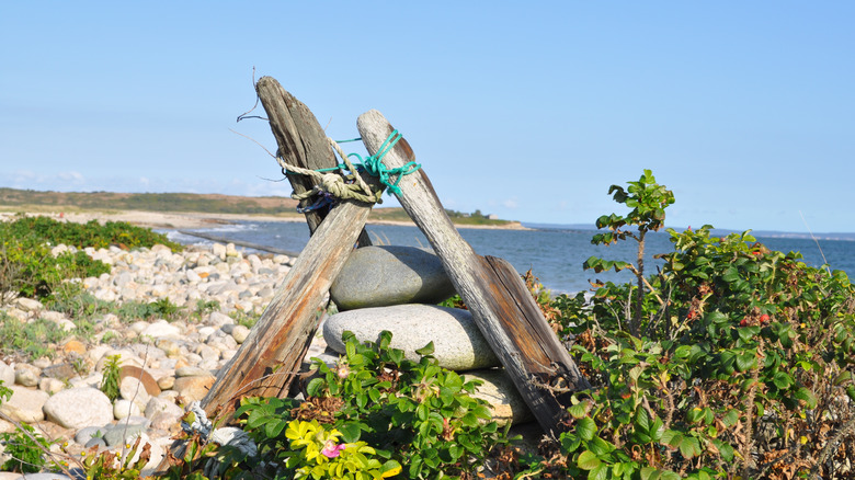 Wooden sculpture on a rocky beach