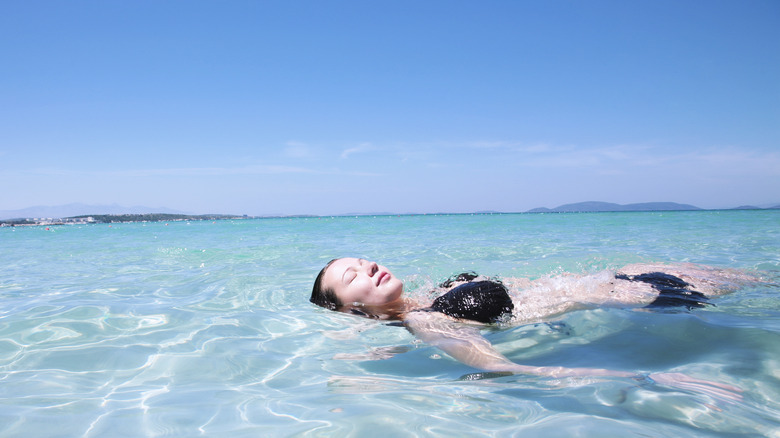 Woman floating in tropical sea