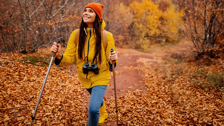 Young woman hiking through fall foliage