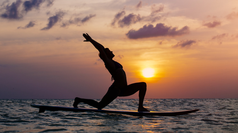Woman practicing SUP yoga