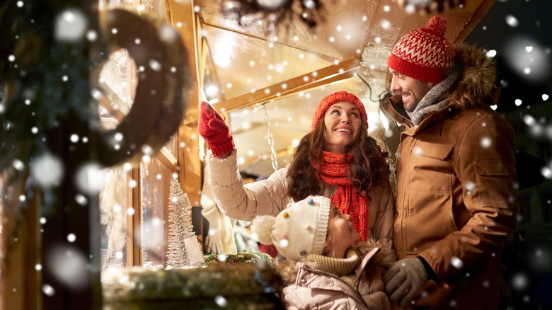 family under Christmas lights