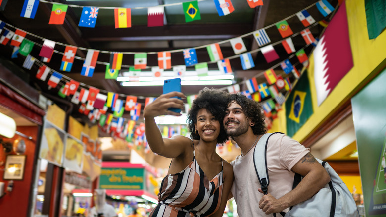 couple taking photo in supermarket