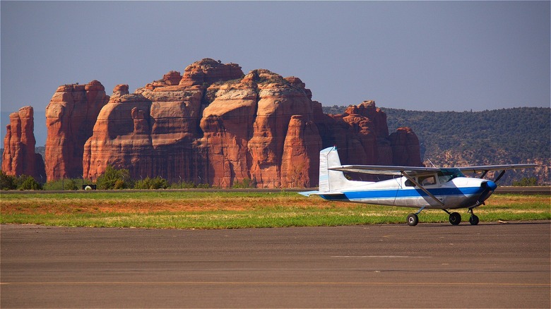 Small aircraft near rock formation