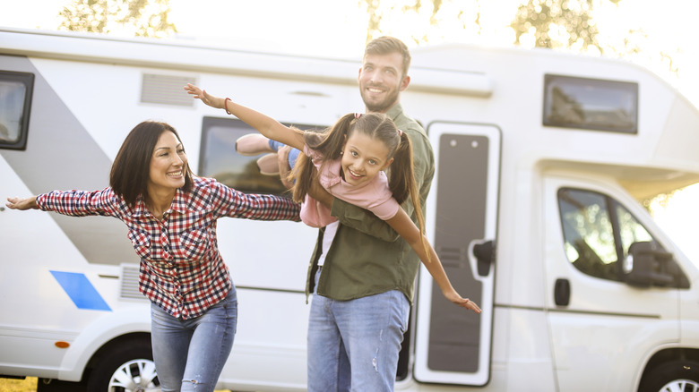 Happy family by a camper van
