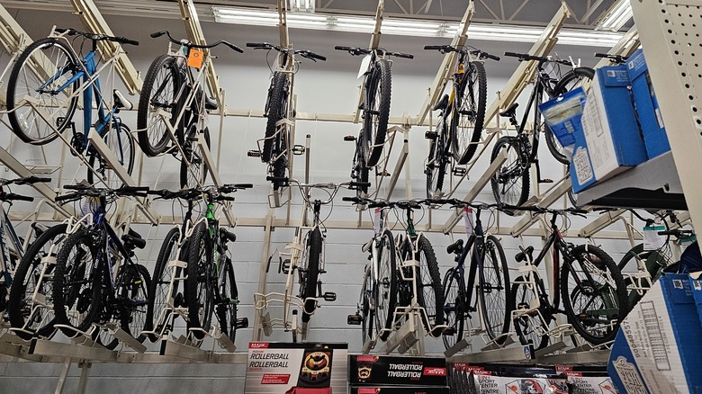 Bicycles hang from display racks in a Walmart store