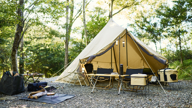 A tent set up in a forested area for camping.